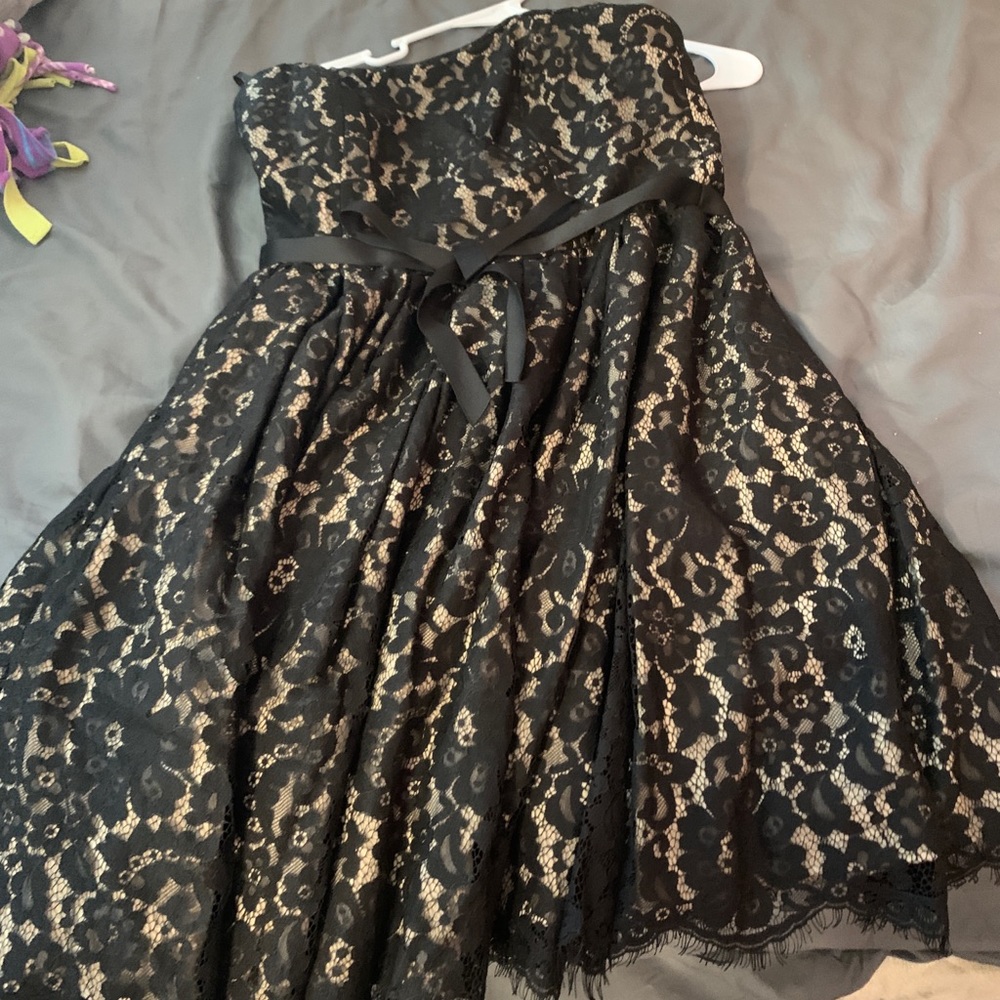 Black lace over nude strapless dress
